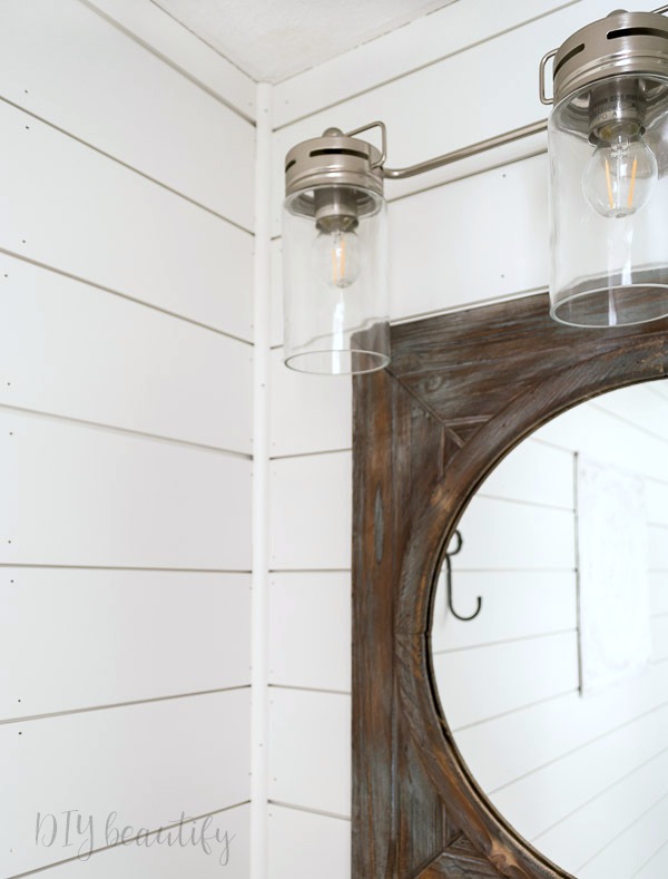 I'm revealing our small bathroom that we made over with products provided by Lowe's to add big farmhouse style! Come see it at DIY beautify! #farmhouse #bathroom #roommakeover #Lowes modern farmhouse light fixture
